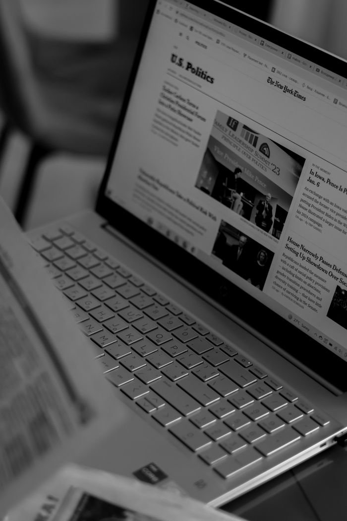 Mastering the First Impression: Your intriguing post title goes here Black and white photo of a laptop showing a news website with focus on U.S. politics section.